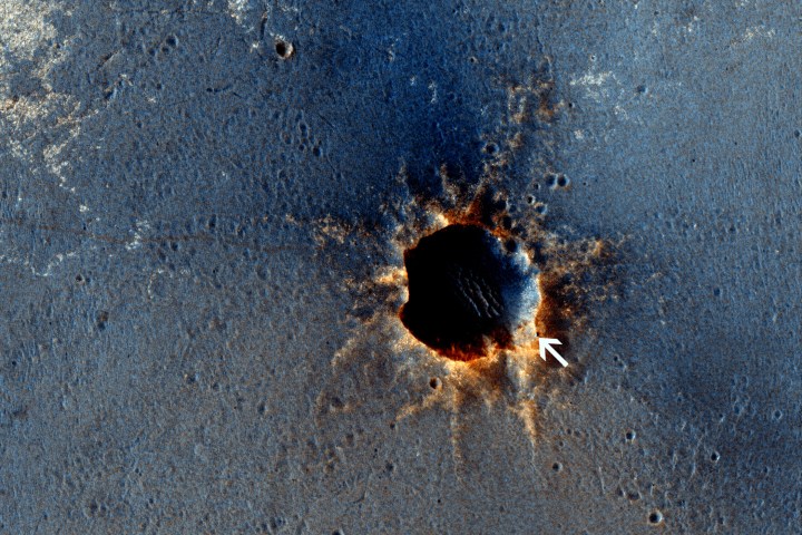 HiRISE acquired this color image of Santa Maria Crater, with the Opportunity rover perched on the southeast rim. Rover tracks are clearly visible to the east.