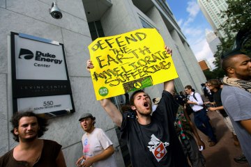 image: A demonstrator yells at spectators and police during a protest in front of the Duke Energy Center during the Democratic National Convention in Charlotte, N.C., Sept. 5, 2012.