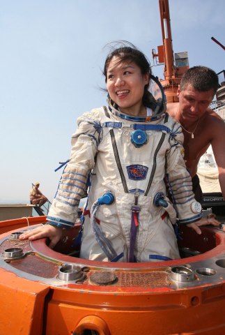 South Korean astronaut Yi So-yeon is helped by Russian specialists as she undergoes a splashdown landing training session in the Ukrainian Black Sea city of Sevastopol, on July 24, 2007.