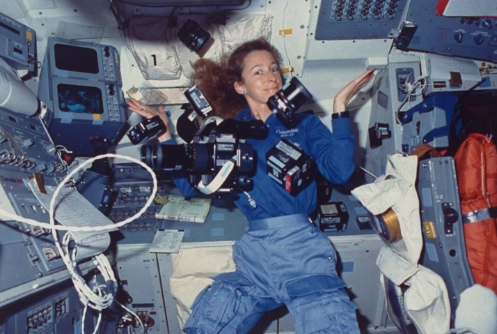 Astronaut Marsha Ivins, mission specialist aboard space shuttle Columbia, surrounded by cameras and supportive gear suspended by zero-gravity, on Jan. 1, 1990.