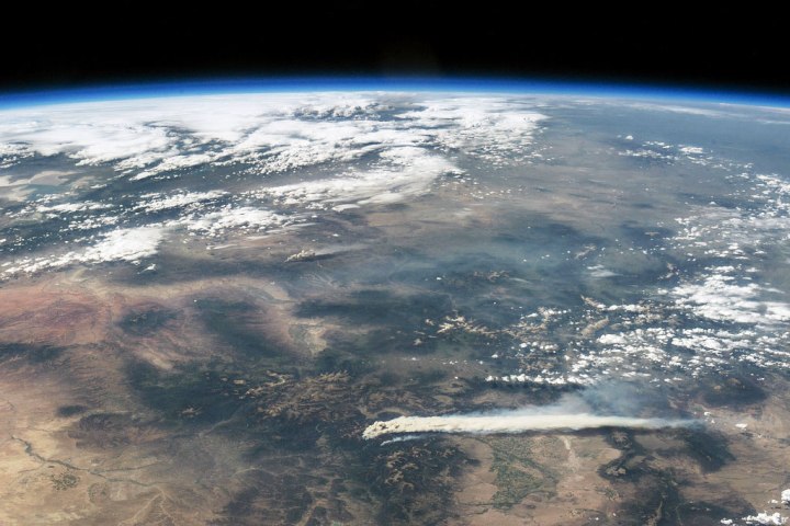 Thick smoke billows across the landscape in these digital photographs of the western United States. Both photographs were taken by astronauts aboard the International Space Station (ISS) on June 19, 2013.