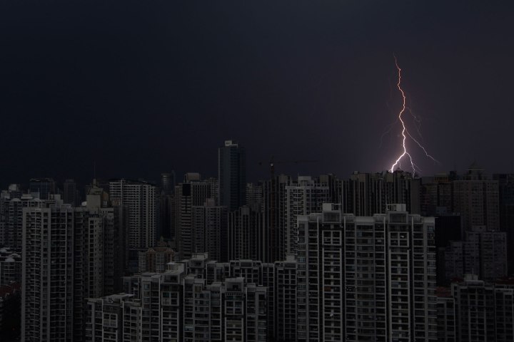 Lightning is seen above buildings during a storm in central Shanghai