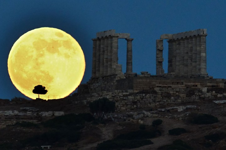 A supermoon rises next to the ancient Greek temple of Poseidon at Cape Sounion, some 65 kilometers south of Athens, on June 23, 2013.