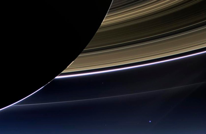 Saturn's rings and our planet Earth and its moon are seen in this NASA handout image