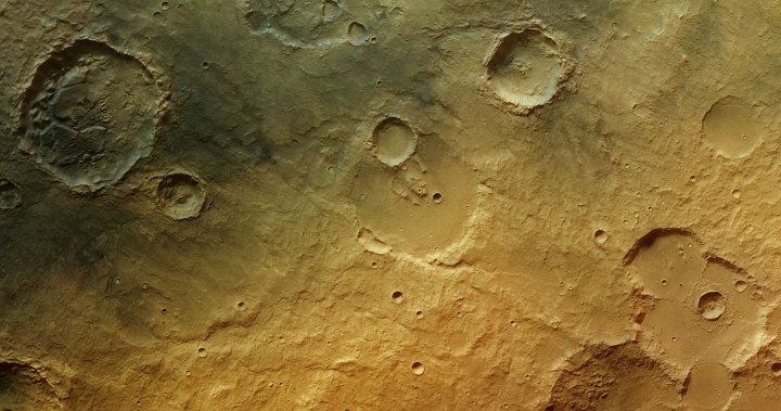 In the ancient cratered southern highlands of Mars, the faint traces of a wet past are seen in the form of channels (lower centre), fluidised debris around craters (bottom right) and blocks of eroded sediments (top left). Volcanic activity may have deposited the fine dusting of dark material visible in the top left.