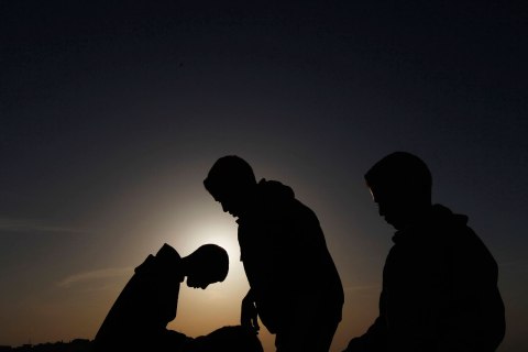 People observe a solar eclipse in Amman, on Nov. 3, 2013.