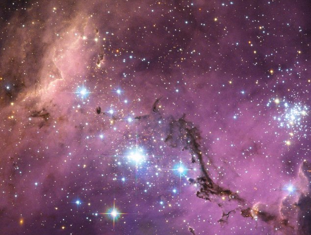 Nearly 200, 000 light-years from Earth, the Large Magellanic Cloud, a satellite galaxy of the Milky Way. As the Milky Way's gravity gently tugs on its neighbour's gas clouds, they collapse to form new stars. In turn, these light up the gas clouds in a kaleidoscope of colours.