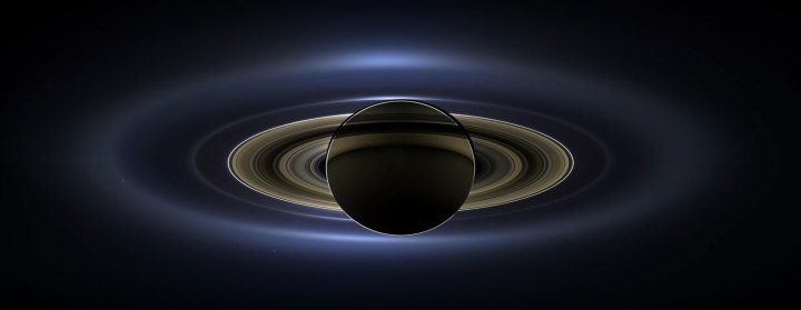 On July 19, 2013, NASA's Cassini spacecraft slipped into Saturn's shadow and photographed the planet and its rings, seven of its moons, and, in the background, the blue speck that is Earth. 