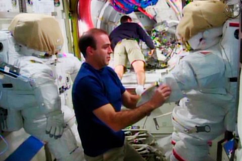 Expedition 38 crew member Mastracchio checks out his spacesuit in the ISS