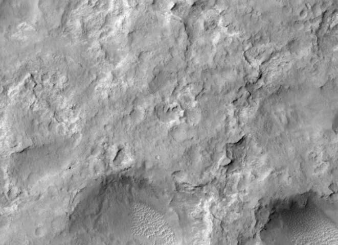 NASA's Curiosity Mars rover and tracks left by its driving appear in this portion of a Dec. 11, 2013