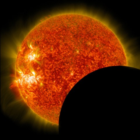 NASA's Solar Dynamics Observatory captured this image of the moon crossing in front of its view of the sun on Jan. 30, 2014, at 10:30 a.m. EST in 171 and 304 angstrom light.