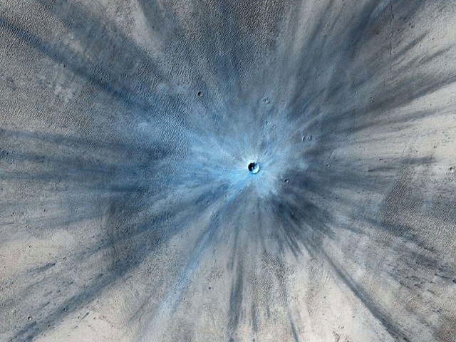 A fresh impact crater, captured by the High Resolution Imaging Science Experiment (HiRISE) camera on NASA's Mars Reconnaissance Orbiter on Nov. 19, 2013 and released on Feb. 5, 2014. 
